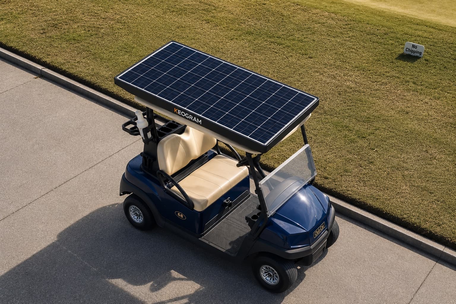 Golf cart fitted with a Keogram roof-mounted solar panel, parked in the sun